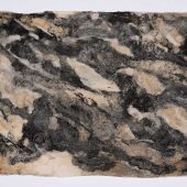 A piece of handmade paper made with detritus