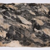 A piece of handmade paper made with detritus