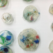 Cast resin installation pins with plastic detritus embedded