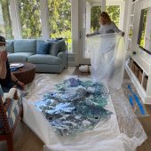A man and woman unpacking an art sculpture