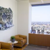 An ocean inspired mixed media art piece on a wall in an office