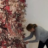 A woman working on a 3D art exhibit