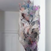 A 3D mixed media sculpture on a white wall