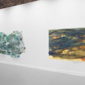 Two mixed media art pieces on a gallery wall