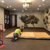 Installing the floor for Hello Sailor Two men setting up a floor base for an art exhibit