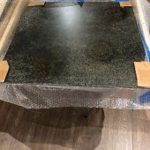 One of the 2 x 2 steel plates for Hello Sailor A steel plate in a crate with nautical carvings on it.