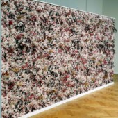 Detail A wall covered in multi-colored pieces of paper