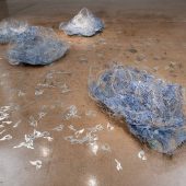 Art sculptures made from plastic and paper on a floor