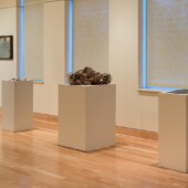 3 mixed media art pieces on pedestals