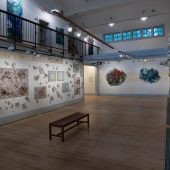 A room in an art gallery with mixed media art sculptures