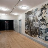 A large mixed media art piece in an art gallery