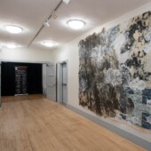 A large mixed media art piece in an art gallery