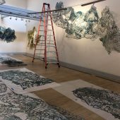 Mixed media art and a ladder in an art gallery