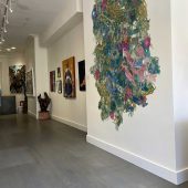 A large mixed media art sculpture on display in an art gallery