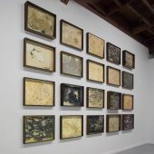 Framed mixed media art on a white wall