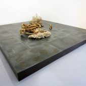 A large mixed media art piece on a floor display