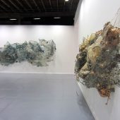 Two mixed media art sculptures covered in netting