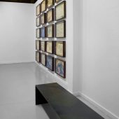 Framed art on a wall and a bench