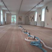 an art exhibit with rope made from paper on the floor