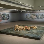 Three mixed media art sculptures in an art gallery