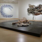 An art exhibit of 3 mixed media art pieces