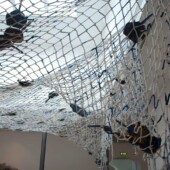 Cotton netting suspended from ceiling in an art gallery